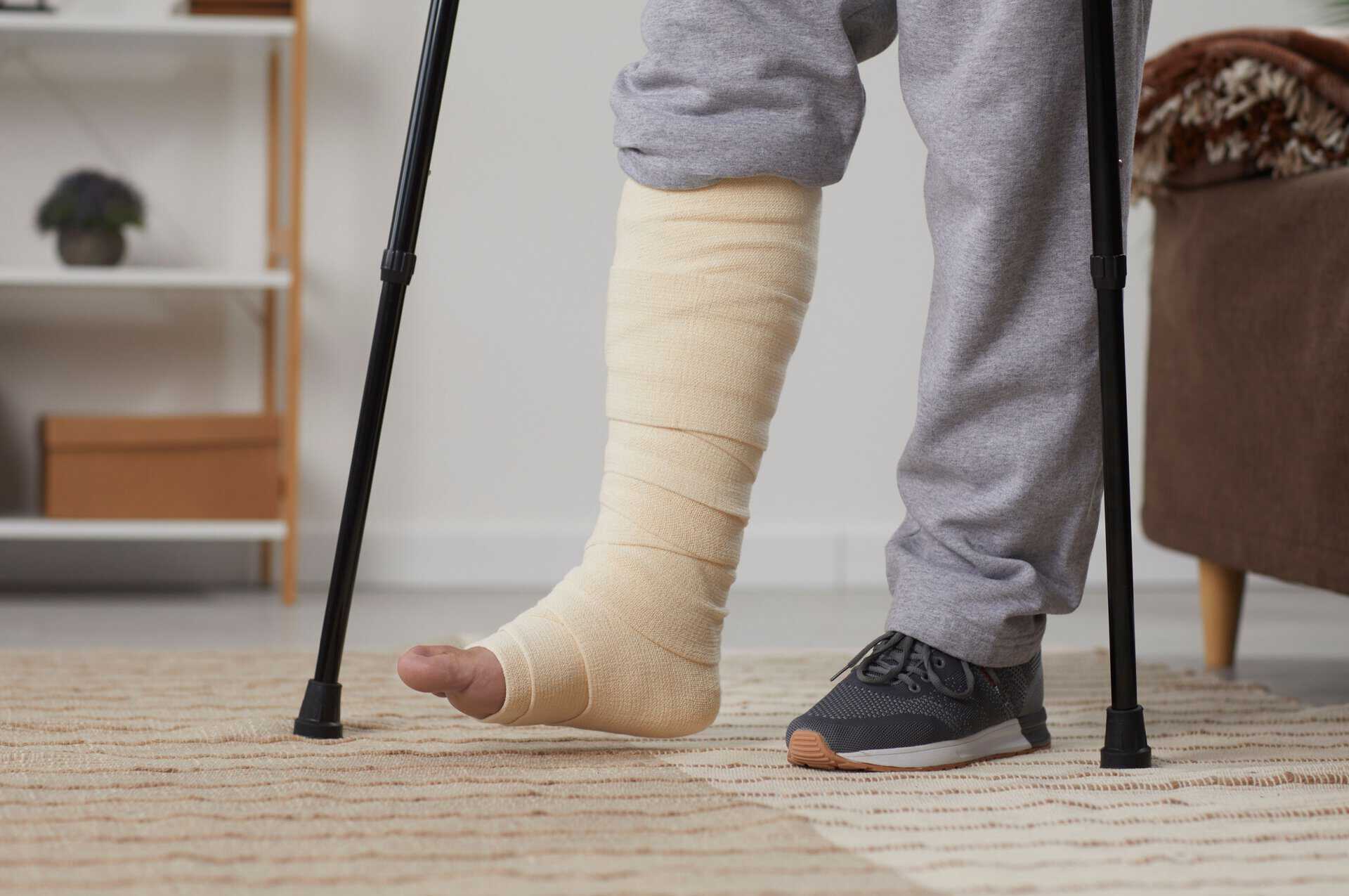 A man with a broken leg using crutches.