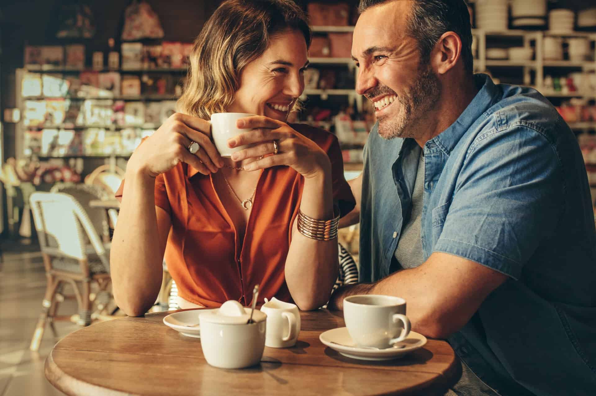 A couple laughing in a café.