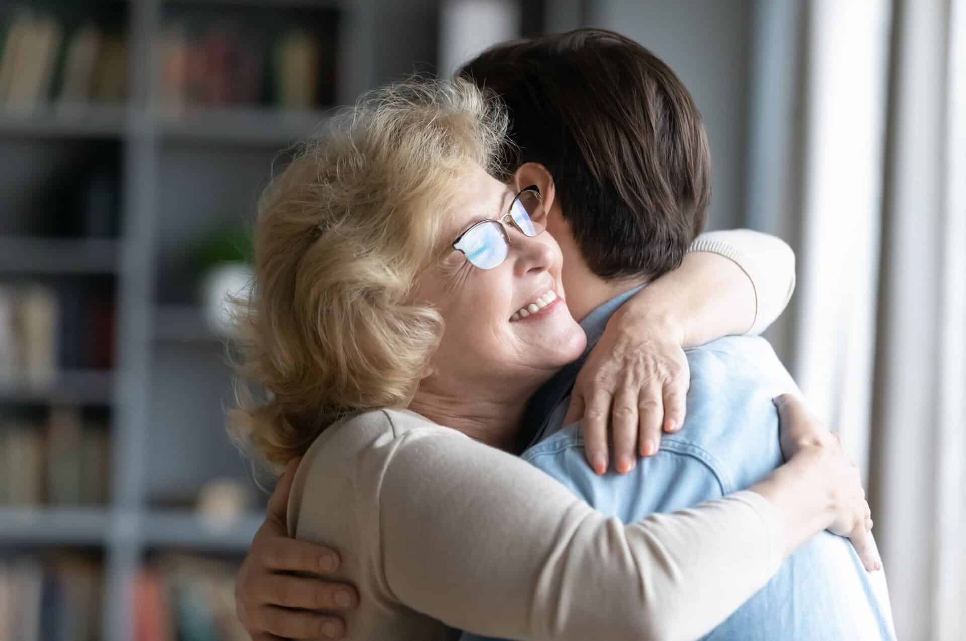 A mother hugging her adult son.
